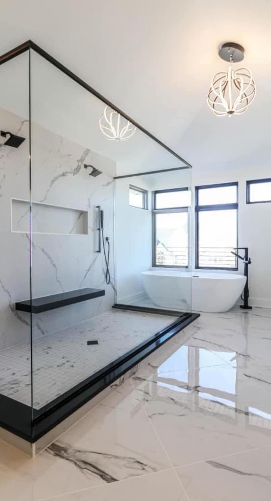 Bathroom with a walk-in glass shower, tiled bench and a freestanding tub