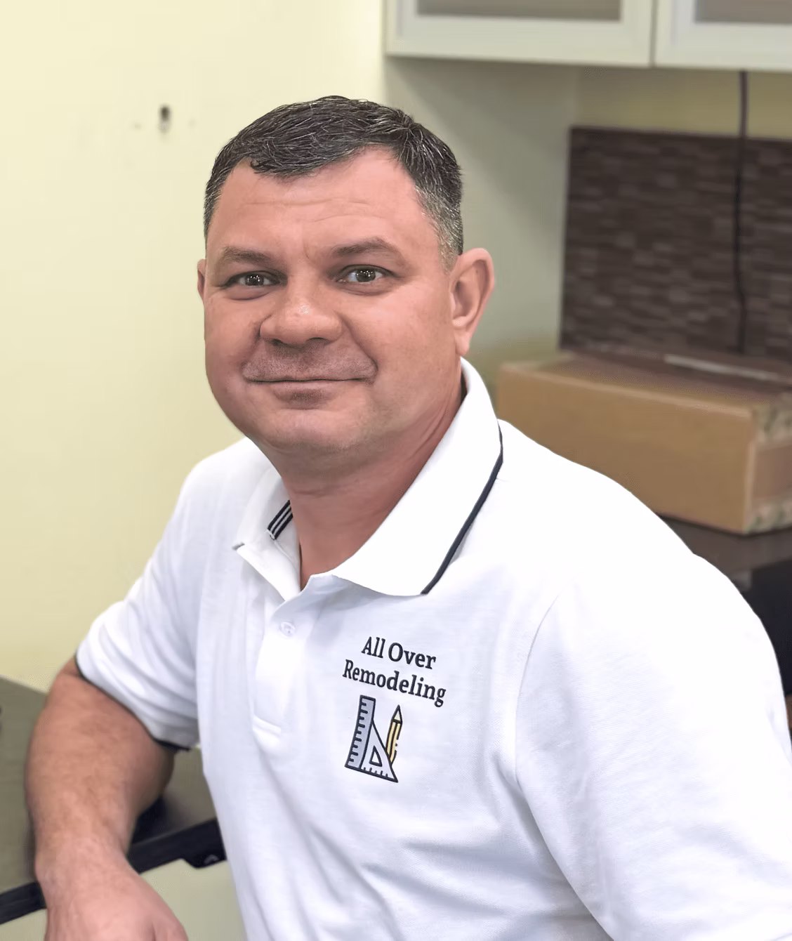 Sergey, owner of All Over Remodeling, in a company polo shirt